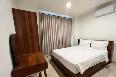 a bedroom with a white bed and a window at Lariska 1 BR Superior Queen Room in Jimbaran