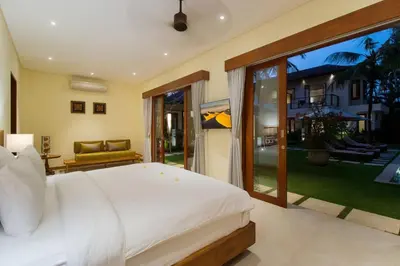 a bedroom with a large white bed and a patio at Super Spacious, 6 Bed, Chef, Daily B'Fast, 12 pax in Seminyak
