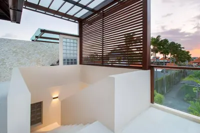 a house with white walls and a large window at Super Spacious, 6 Bed, Chef, Daily B'Fast, 12 pax in Seminyak