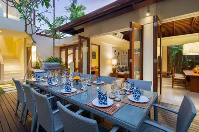 a dining table and chairs on a patio at Super Spacious, 6 Bed, Chef, Daily B'Fast, 12 pax in Seminyak