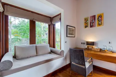 a room with a window seat with a chair and a desk at Super Spacious, 6 Bed, Chef, Daily B'Fast, 12 pax in Seminyak