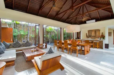 an open living room and dining room with a table and chairs at Super Spacious, 6 Bed, Chef, Daily B'Fast, 12 pax in Seminyak