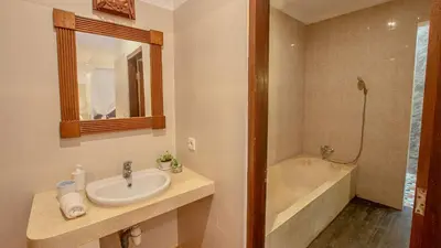 a bathroom with a sink and a bath tub at Leluhur 2 - 3BR, Free Nmax, Airport Pick Up and YT Premium in Seminyak
