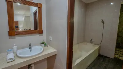 a bathroom with a sink and a bath tub at Leluhur 2 - 3BR, Free Nmax, Airport Pick Up and YT Premium in Seminyak