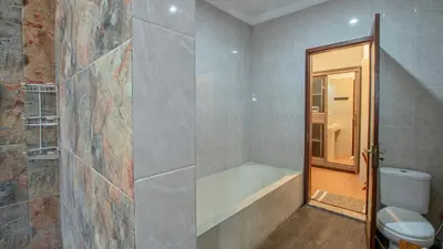 a bathroom with a bath tub and a toilet at Leluhur 2 - 3BR, Free Nmax, Airport Pick Up and YT Premium in Seminyak