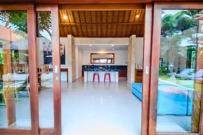 a room with a kitchen with a table in it at Minara 4 BR Private Pool Villa in Canggu