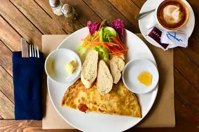 a plate of food with an omelet and eggs and a salad at Minara 4 BR Private Pool Villa in Canggu