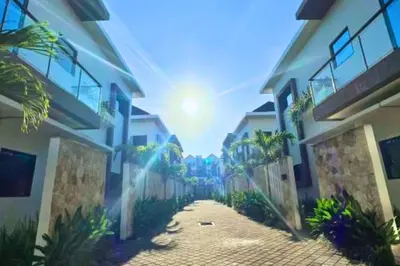 a view of a street between two buildings at Anyaa 3 BR Apartment in Jimbaran