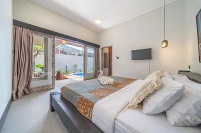 a bedroom with a large bed and a large window at Villa Thyme, secluded 2 bedroom pool Villa, 2 minutes walking to cafe in Canggu