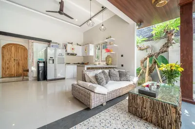 a living room with a couch and a kitchen at Villa Thyme, secluded 2 bedroom pool Villa, 2 minutes walking to cafe in Canggu