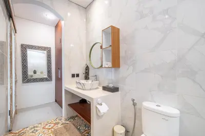 a bathroom with a toilet and a sink and a mirror at Villa Thyme, secluded 2 bedroom pool Villa, 2 minutes walking to cafe in Canggu