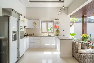 a kitchen with white cabinets and a sink at Villa Thyme, secluded 2 bedroom pool Villa, 2 minutes walking to cafe in Canggu