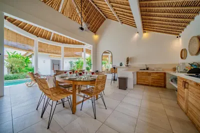 a kitchen and dining room with a table and chairs at Villa Antea in Seminyak
