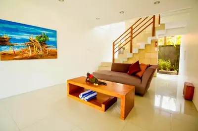 a living room with a couch and a coffee table at Camana 1 BR Villa With Shared Pool in Canggu