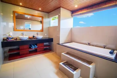 a bathroom with two sinks and a bath tub at Camana 1 BR Villa With Shared Pool in Canggu
