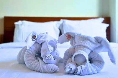 two stuffed animals are sitting on a bed at Abimana 5 BR Presidential Suite Private Pool in Jimbaran