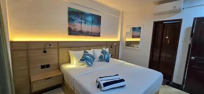 a bedroom with a bed with a toaster on it at C&C Jayakarta Residence Apartment Legian Kuta Bali in Seminyak