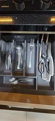 a drawer filled with utensils in an oven at C&C Jayakarta Residence Apartment Legian Kuta Bali in Seminyak