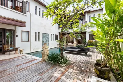 a courtyard with a swimming pool in a house at Villa Raja Seminyak by KING in Seminyak
