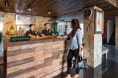 a woman standing in front of a bar at Hadi Poetra Hotel in Kuta