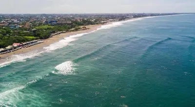 an aerial view of a beach and the ocean at La Bumbak in Canggu