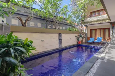 a swimming pool in front of a house at OYO Life 92852 Singgah Hotel Legian in Legian