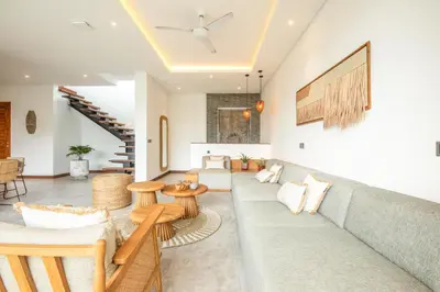 a living room with a couch and tables at Coastal Elegance 4BR Villa, 400m to Finns in Canggu