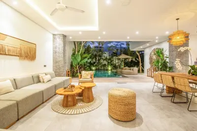 a living room with a couch and a table at Coastal Elegance 4BR Villa, 400m to Finns in Canggu