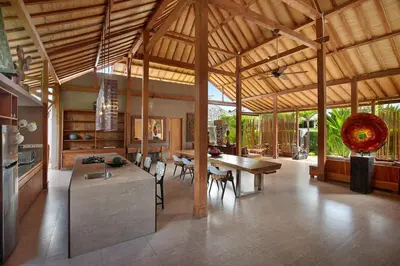 a large kitchen and dining room with a wooden ceiling at Villa Gahana Bali in Seminyak