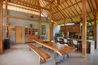 a large kitchen with a wooden table and a dining room at Villa Gahana Bali in Seminyak