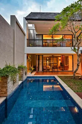 a swimming pool in the backyard of a house at The Cabana Villa in Seminyak