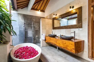 a bathroom with two sinks and a large tub at Villa Shantika by Villa Finder in Seminyak