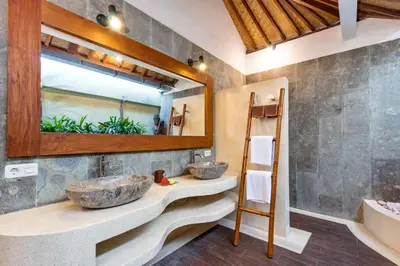two sinks in a bathroom with a mirror at Villa Shantika by Villa Finder in Seminyak