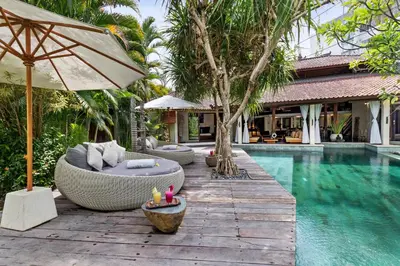 a resort with a swimming pool and a resort with a villa at Villa Shantika by Villa Finder in Seminyak