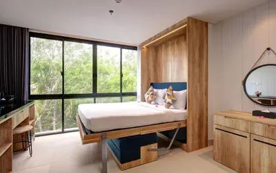 a bedroom with a bed and a large window at Anagata Paradiso Bali in Nusa Dua