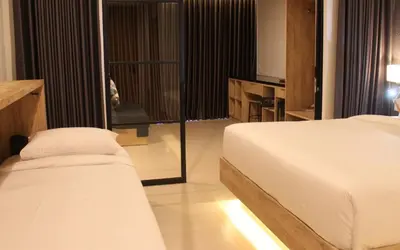 a bedroom with a bed and a view of a balcony at Anagata Paradiso Bali in Nusa Dua