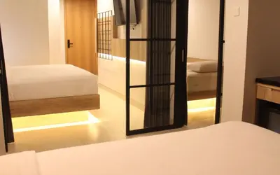 a bedroom with a mirror and a bed in a room at Anagata Paradiso Bali in Nusa Dua