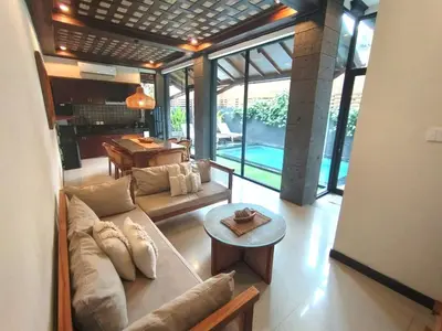 a living room with a couch and a table at Villa CUCU - Legian - 3 Bedroom in Legian