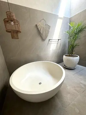 a bathroom with a white sink and a potted plant at Villa CUCU - Legian - 3 Bedroom in Legian