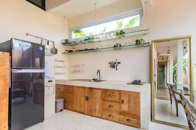 a kitchen with a sink and a refrigerator at Villa Pisces - 2 Bedrooms Villa with Private Pool at Kerobokan in Denpasar