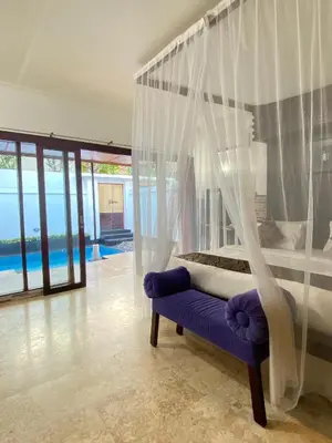 a bedroom with a bed with a canopy at One Bedroom Private Pool Classic Villa in Kuta