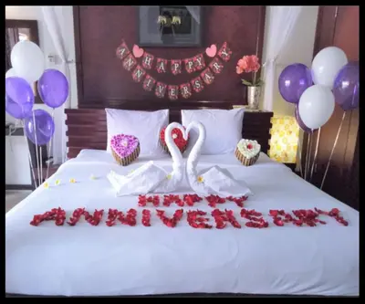 a bed with a swan and some cupcakes and balloons at One Bedroom Private Pool Classic Villa in Kuta