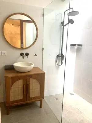 a bathroom with a sink and a mirror at Villa VALARI - Seminyak Legian - 5 Bedrooms in Seminyak