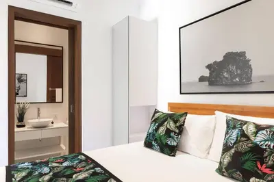 a bedroom with a bed with a sink and a mirror at Villa Nook in Seminyak