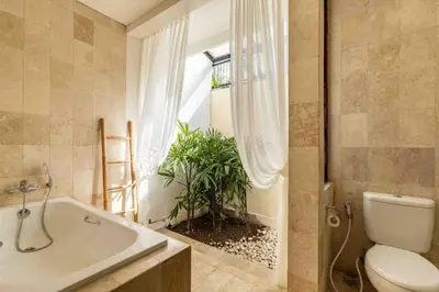 a bathroom with a tub and a toilet and a plant at 2 Bedroom private Pool Seminyak in Seminyak