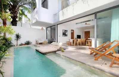 a house with a swimming pool with a villa at Jipsi Villas Canggu in Canggu
