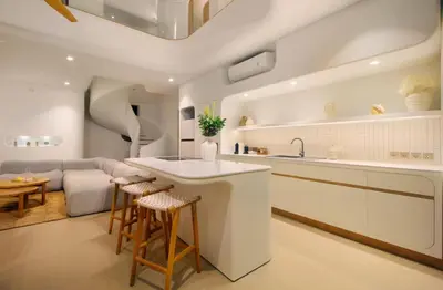 a kitchen and living room with a couch and a table at Jipsi Villas Canggu in Canggu