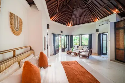 a living room with a couch and a table at Villa Coconut Heaven by Bali Villa Solutions in Seminyak