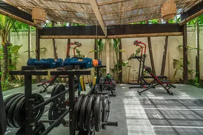 a gym with dumbbells and other equipment in it at Villa Coconut Heaven by Bali Villa Solutions in Seminyak