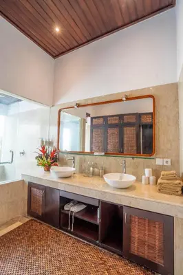 a bathroom with two sinks and a large mirror at Villa Coconut Heaven by Bali Villa Solutions in Seminyak